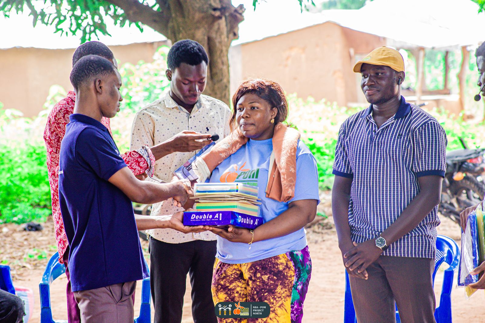 Team members hand over exercise books